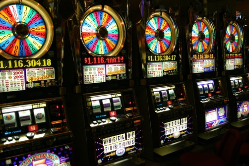 Five empty casino slot machines which may have bonuses that are subject to 35x wagering
