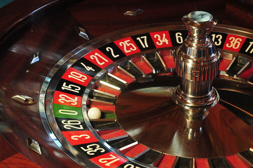 roulette wheel with ball in green pocket