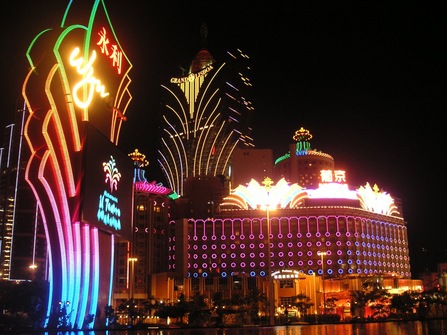 A land casino light up in neon green, yellow, orange, pink, and blue.
